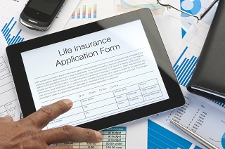 image of man filling out life insurance application